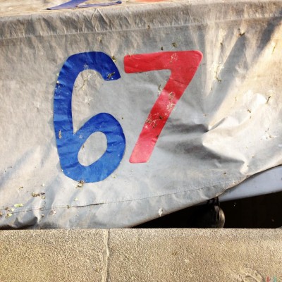 hand made red and blue number 67 on a boat in Amsterdam