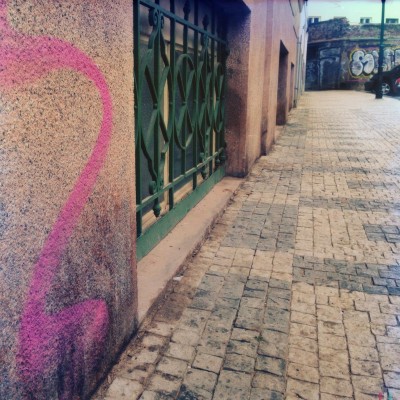 hand sprayed pink street number 2 on a wall in Prague