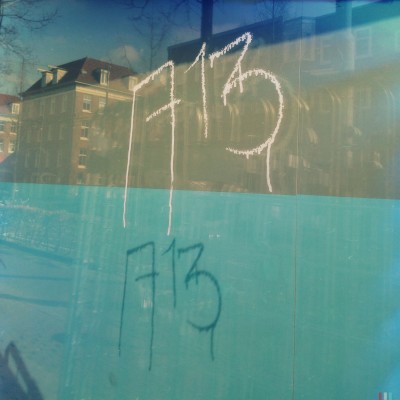 white hand written on a window glass number 713 in Amsterdam