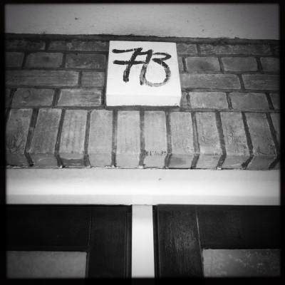 house number 713 on top of two doors on a brick facade in Amsterdam