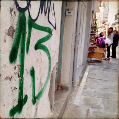 green number 13 handwritten on a white wall in Rethymno Crete