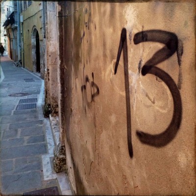 black hand written number 13 on the wall in Rethymno Crete