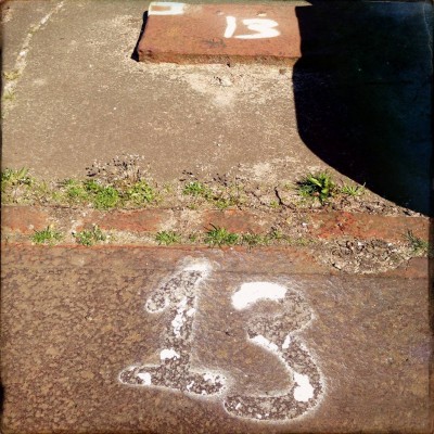 white sprayed number 13 on the ground in Amsterdam