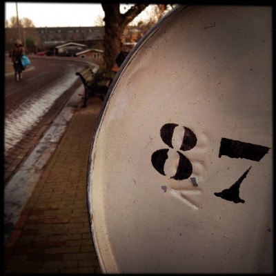 black number 87 on a barrel in Amsterdam