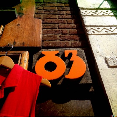 orange retro letter type house number 83 in Amsterdam