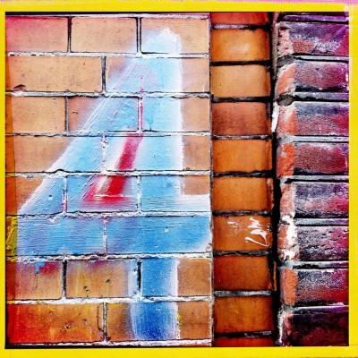 hand painted number 4 on a brick wall, in Amsterdam