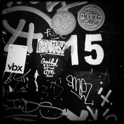 street number 15 on a door with graffiti and stickers in Amsterdam