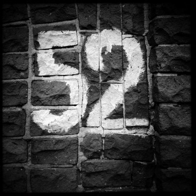 white hand sprayed street number 52 on a brick wall in Amsterdam