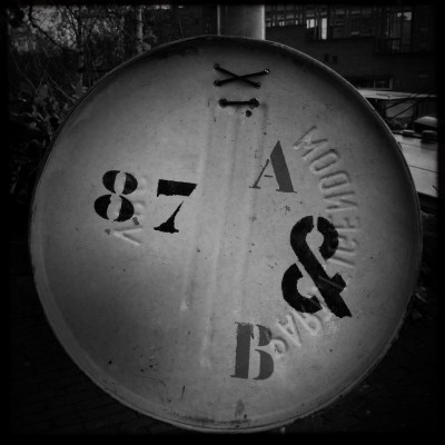 street number 87 on a metal barrel in Amsterdam