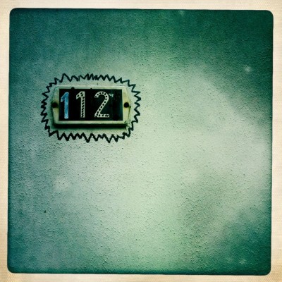 House number 112 on a wall with marker decoration in Antwerp