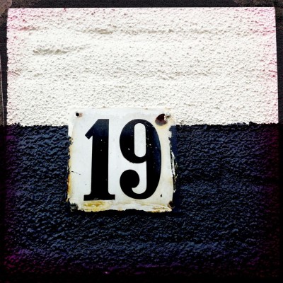 house number 19 on a black and white wall in Amsterdam