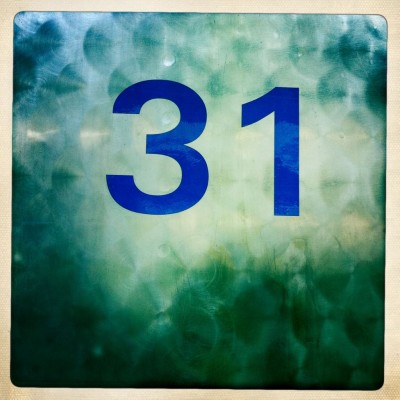 Blue street number 31 on metal surface in Amsterdam